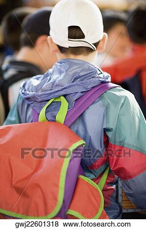 Stock Photo - Rear view of a man carrying a backpack, Rome, Italy. Fotosearch