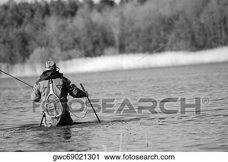 Rear view of a man fishing in the river View Large Photo Image Stock Image - Rear view of a man fishing in the river. Fotosearch