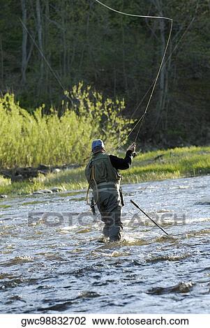 Rear view of a man fishing in the river View Large Photo Image Stock Image - Rear view of a man fishing in the river. Fotosearch