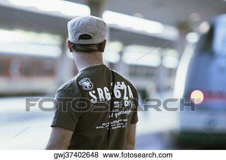 Rear view of a man standing at a railroad station, Rome, Italy View Large Photo Image Stock Photo - Rear view of a man standing at a railroad station, Rome, Italy. Fotosearch