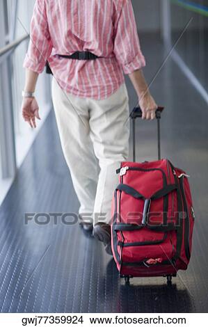 Rear view of a man walking and carrying a bag, Madrid, Spain View Large Photo Image Picture - Rear view of a man walking and carrying a bag, Madrid, Spain. Fotosearch