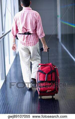 Rear view of a man walking and carrying a bag, Madrid, Spain View Large Photo Image Stock Photography - Rear view of a man walking and carrying a bag, Madrid, Spain. Fotosearch