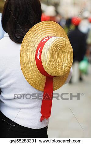 Rear view of a woman holding a hat View Large Photo Image Stock Image - Rear view of a woman holding a hat. Fotosearch