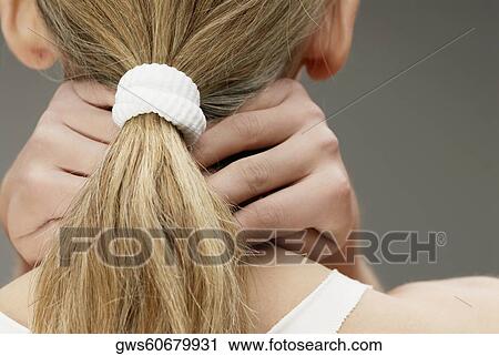 Rear view of a woman with her hands behind her head View Large Photo Image Stock Image - Rear view of a woman with her hands behind her head. Fotosearch