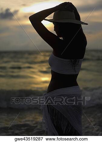 Rear view of a young woman wearing a sun hat View Large Photo Image Stock Photo - Rear view of a young woman wearing a sun hat. Fotosearch