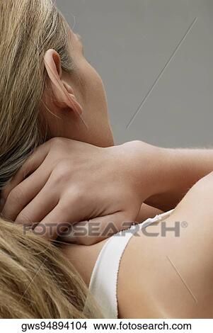 Rear view of a young woman with her hands behind her head View Large Photo Image Picture - Rear view of a young woman with her hands behind her head. Fotosearch
