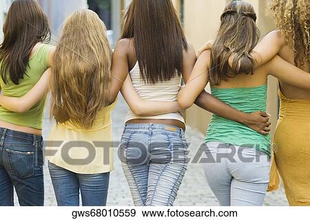 Rear view of five teenage girls walking with their arm around each other View Large Photo Image Stock Photo - Rear view of five teenage girls walking with their arm around each other. Fotosearch