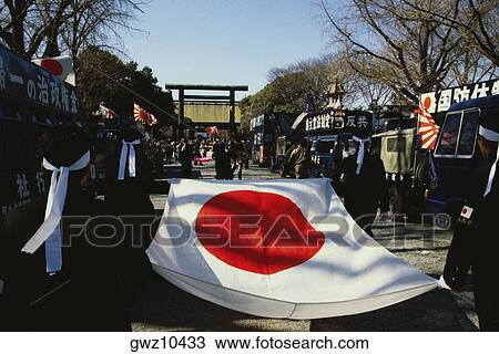 Rear view of four people carrying a Japanese flag, Yasukuni Shrine, Tokyo Prefecture, Japan View Large Photo Image Stock Image - Rear view of four people carrying a Japanese flag, Yasukuni Shrine, Tokyo Prefecture, Japan. Fotosearch
