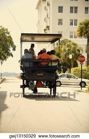 Rear view of people traveling in a horse cart, Savannah, Georgia, USA View Large Photo Image Stock Photo - Rear view of people traveling in a horse cart, Savannah, Georgia, USA. Fotosearch