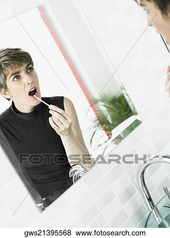 Reflection of a mature woman applying lipstick View Large Photo Image Stock Photo - Reflection of a mature woman applying lipstick. Fotosearch