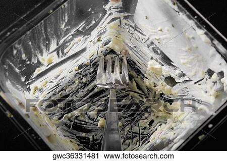 Stock Image - Remains of a messy bowl with a fork. Fotosearch