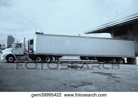 Stock Image - Semi-truck at a shipping port. Fotosearch