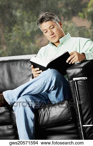 Picture - Senior man reading a book. Fotosearch