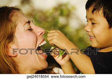 Picture - Side profile of a boy and his mother playing. Fotosearch
