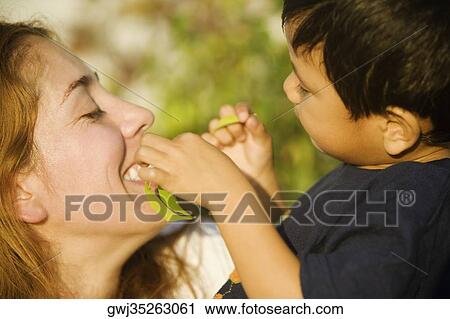 Side profile of a boy and his mother playing View Large Photo Image Stock Image - Side profile of a boy and his mother playing. Fotosearch