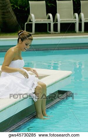 Side profile of a bride sitting at the poolside and smiling View Large Photo Image Stock Photography - Side profile of a bride sitting at the poolside and smiling. Fotosearch