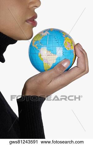 Side profile of a businesswoman holding a globe View Large Photo Image Stock Image - Side profile of a businesswoman holding a globe. Fotosearch
