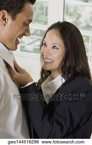 Side profile of a businesswoman looking at a businessman and smiling View Large Photo Image Stock Photograph - Side profile of a businesswoman looking at a businessman and smiling. Fotosearch