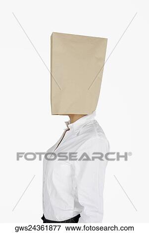 Side profile of a businesswoman covering her face with a paper bag View Large Photo Image Stock Photo - Side profile of a businesswoman covering her face with a paper bag. Fotosearch