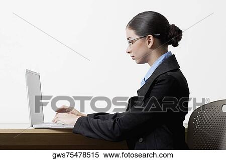 Side profile of a businesswoman using a laptop View Large Photo Image Stock Photography - Side profile of a businesswoman using a laptop. Fotosearch