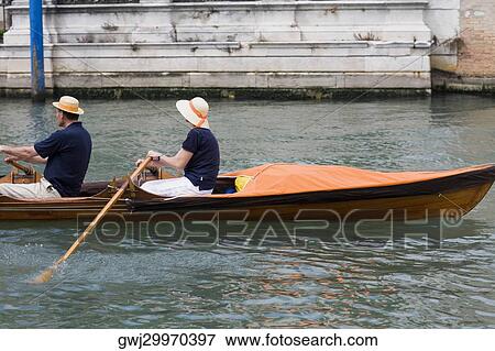 Side profile of a couple rowing a canoe, Venice, Veneto, Italy View Large Photo Image Stock Photo - Side profile of a couple rowing a canoe, Venice, Veneto, Italy. Fotosearch