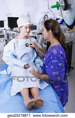 Side profile of a female doctor examining a female patient with a stethoscope View Large Photo Image Stock Image - Side profile of a female doctor examining a female patient with a stethoscope. Fotosearch
