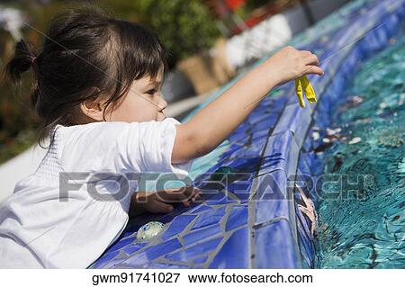 Side profile of a girl holding a balloon at the poolside View Large Photo Image Stock Photo - Side profile of a girl holding a balloon at the poolside. Fotosearch