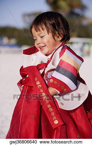 Side profile of a girl in traditional clothing smiling View Large Photo Image Stock Image - Side profile of a girl in traditional clothing smiling. Fotosearch