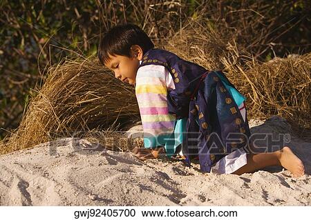 Side profile of a girl kneeling on the sand, Miami, Florida, USA View Large Photo Image Stock Image - Side profile of a girl kneeling on the sand, Miami, Florida, USA. Fotosearch