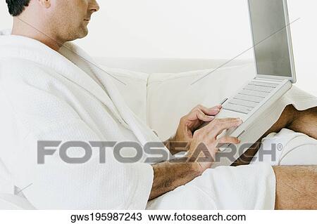 Side profile of a man using a laptop View Large Photo Image Stock Image - Side profile of a man using a laptop. Fotosearch
