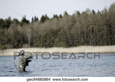 Side profile of a mature man fishing in the river View Large Photo Image Picture - Side profile of a mature man fishing in the river. Fotosearch