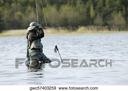 Side profile of a mid adult man fishing in the river View Large Photo Image Stock Photo - Side profile of a mid adult man fishing in the river. Fotosearch
