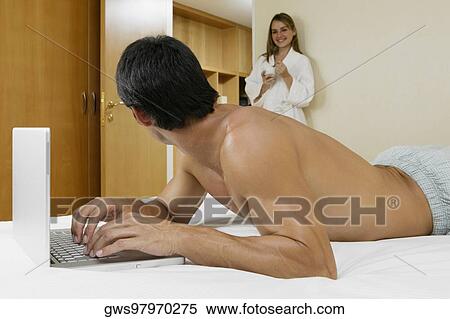 Side profile of a mid adult man using a laptop View Large Photo Image Stock Photography - Side profile of a mid adult man using a laptop. Fotosearch