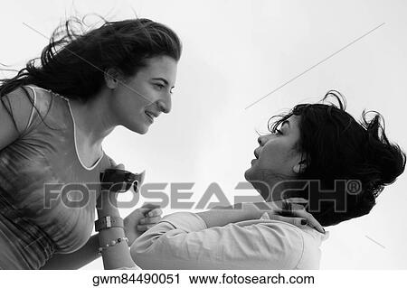 Side profile of a mid adult woman talking to a young woman View Large Photo Image Stock Image - Side profile of a mid adult woman talking to a young woman. Fotosearch