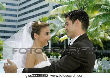Side profile of a newlywed couple facing each other View Large Photo Image Stock Image - Side profile of a newlywed couple facing each other. Fotosearch