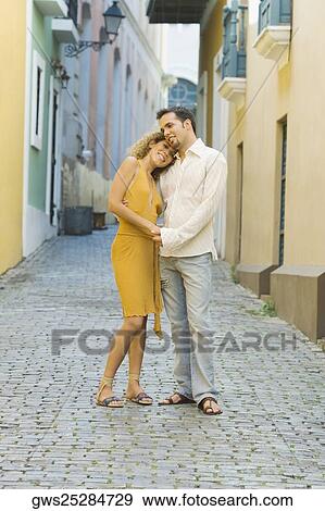 Side profile of a teenage girl and a mid adult man embracing each other on the street View Large Photo Image Stock Photo - Side profile of a teenage girl and a mid adult man embracing each other on the street. Fotosearch