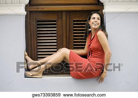 Side profile of a teenage girl sitting on a window sill and smiling View Large Photo Image Stock Photo - Side profile of a teenage girl sitting on a window sill and smiling. Fotosearch