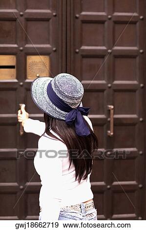 Side profile of a woman opening a door View Large Photo Image Stock Photo - Side profile of a woman opening a door. Fotosearch