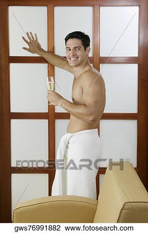 Side profile of a young man holding a champagne flute View Large Photo Image Stock Image - Side profile of a young man holding a champagne flute. Fotosearch