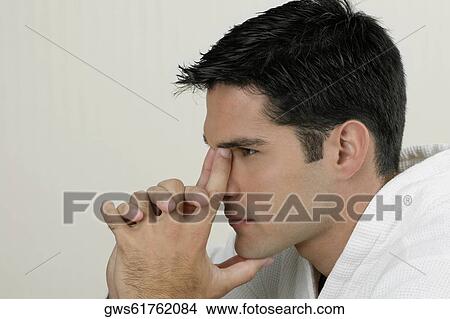 Side profile of a young man looking pensive View Large Photo Image Picture - Side profile of a young man looking pensive. Fotosearch