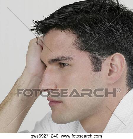 Side profile of a young man thinking with his head in his hand View Large Photo Image Stock Image - Side profile of a young man thinking with his head in his hand. Fotosearch