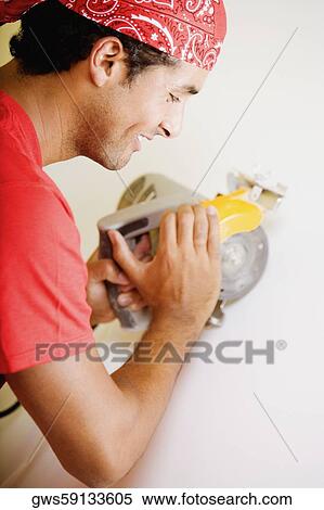 Side profile of a young man working with a circular saw View Large Photo Image Stock Photography - Side profile of a young man working with a circular saw. Fotosearch