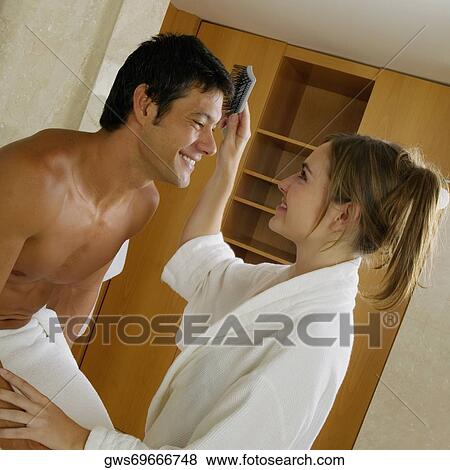 Side profile of a young woman brushing a mid adult man's hair View Large Photo Image Stock Photo - Side profile of a young woman brushing a mid adult man's hair. Fotosearch