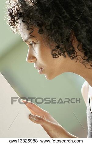 Side profile of a young woman looking serious View Large Photo Image Stock Photo - Side profile of a young woman looking serious. Fotosearch