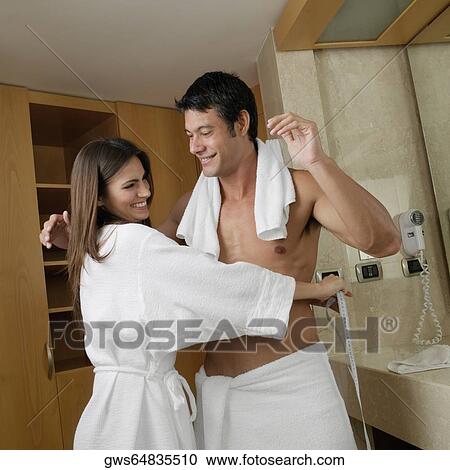 Side profile of a young woman measuring a mid adult man's waist View Large Photo Image Stock Image - Side profile of a young woman measuring a mid adult man's waist. Fotosearch