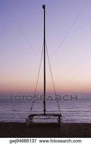 Silhouette of a sailboat on the beach View Large Photo Image Stock Photo - Silhouette of a sailboat on the beach. Fotosearch