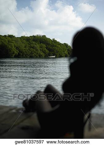 Silhouette of a young woman View Large Photo Image Stock Photo - Silhouette of a young woman. Fotosearch