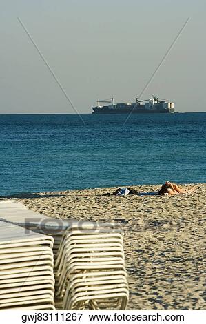 Stack of lounge chairs on the beach View Large Photo Image Stock Photo - Stack of lounge chairs on the beach. Fotosearch