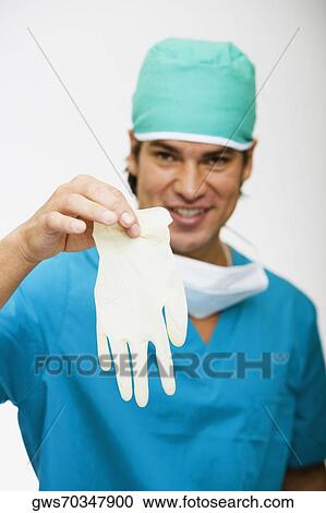 Surgeon showing a surgical glove View Large Photo Image Stock Image - Surgeon showing a surgical glove. Fotosearch
