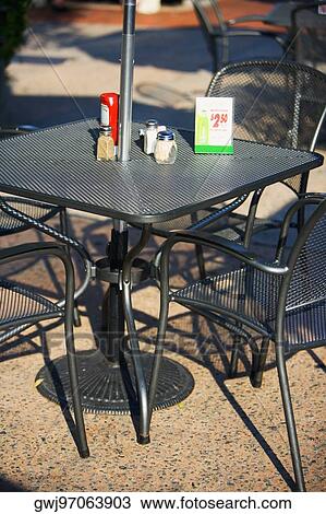 Table and chairs at a sidewalk cafe View Large Photo Image Stock Image - Table and chairs at a sidewalk cafe. Fotosearch